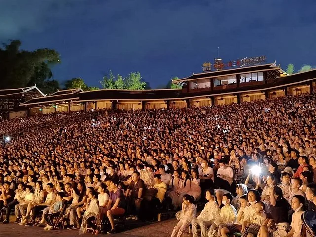 Large audience watching a night performance at the Impression Sanjie Liu theater